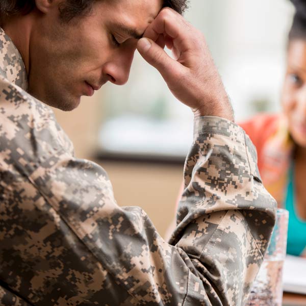 man depressed with hand on head